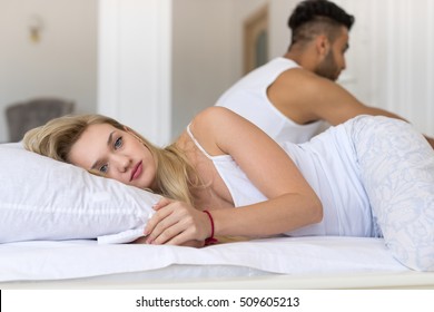 Young Couple Lying In Bed, Having Conflict Problem, Sad Negative Emotions Hispanic Man And Woman Lovers In Bedroom