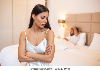 Young couple lying in bed under blanket in bedroom at home, man sleeping, pensive frustrated woman in lingerie thinking about relationships, cheat, treason, family having sexual problems close up