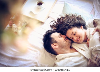 Young couple lying together in bed. - Powered by Shutterstock