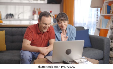 Young couple make video calls with their loved ones at their home on the computer Remote communication concept. 