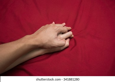 Young couple making love in bed focus on hand