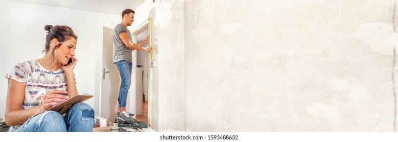 Young Couple Making Plans While Renovating The New Dwelling, Pho