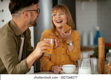 Young Couple Making Sandwich At Home. Loving Couple Enjoying In The Kitchen