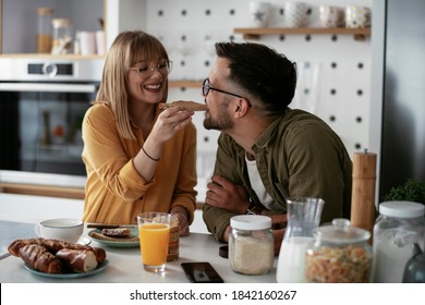 Young Couple Making Sandwich At Home. Loving Couple Enjoying In The Kitchen.	