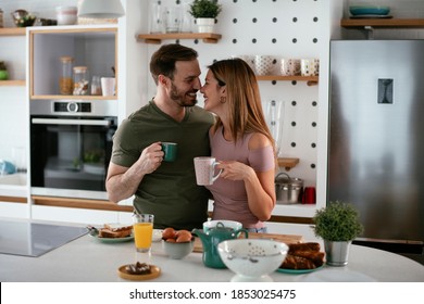 Young Couple Making Sandwich At Home. Loving Couple Enjoying In The Kitchen	