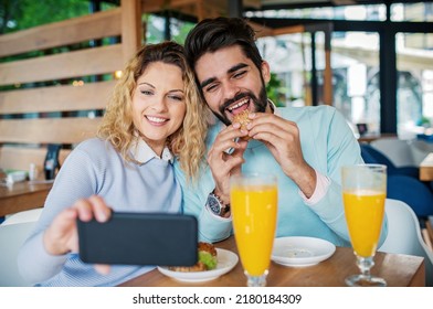 Young Couple Making A Selfie During The Breakfast In A Cafe. Love, Dating, Food, Lifestyle Concept