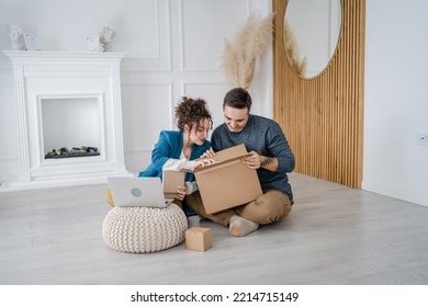 Young Couple Man And Woman Boyfriend And Girlfriend Or Husband And Wife Exchange Gifts At Home Giving Presents To Each Other And Opening Box Happy Smile Celebrate Valentine Holiday Or Birthday