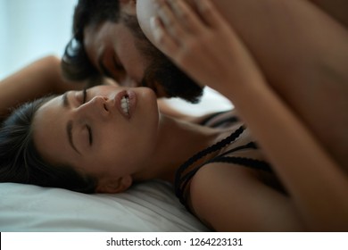 Young horny couple having romantic sex on the bed