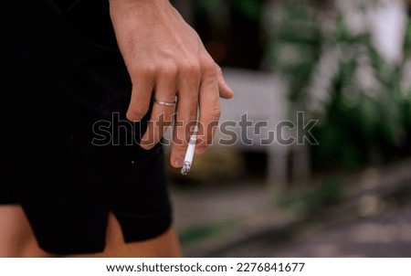 Young couple of man and woman smoking cigarette together