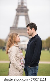 Young Couple, Man And Woman Standing In Front Of Eifel Tower, Paris, France, Looking In Each Others Eyes