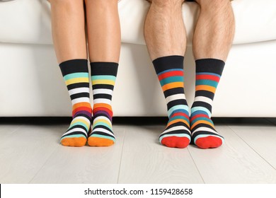 Young Couple In Matching Socks On Couch Indoors, Closeup