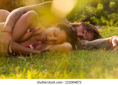 young couple in meadow - Shutterstock ID 121004872