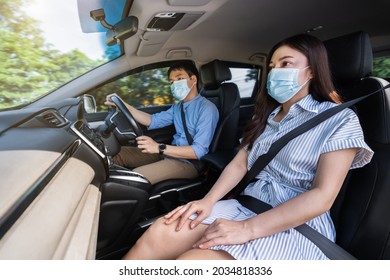 Young Couple In Medical Mask While Driving A Car. For Protect Covid-19 (coronavirus) Pandemic