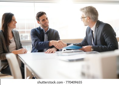 Young Couple Meeting Financial Advisor For Home Investment