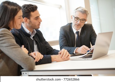 Young Couple Meeting Financial Advisor For Home Investment