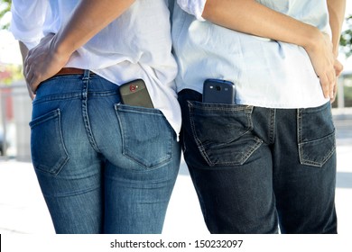 Young couple with mobile in the pocket