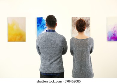 Young Couple In Modern Art Gallery