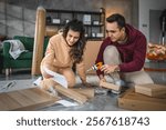 young couple moving in new apartment carry assembly furniture