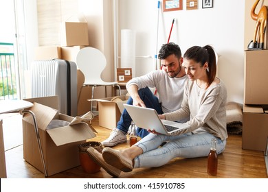 Young couple Moving in new home.Sitting on floor and relaxing after cleaning and unpacking.