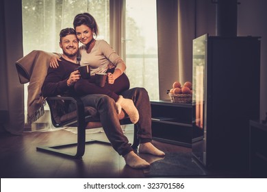 Young Couple Near Fireplace At Home 