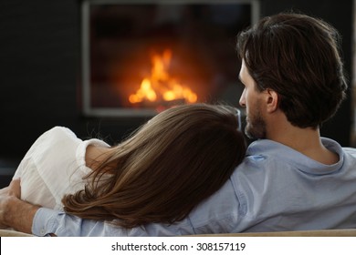 Young Couple Next To The Fireplace