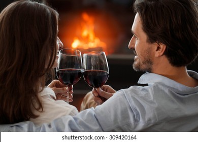 Young Couple Next To The Fireplace