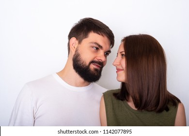 Young couple nice smiling and looks each to other on a light background