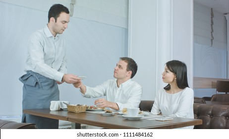 Young couple not liking their food and asking waiter to take it away - Powered by Shutterstock