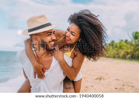 Young Couple On Beach Summer Vacation, Happy Smiling Man Carry Woman Back Seaside