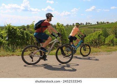 Young couple on a bicycle tour in the vineyards - Powered by Shutterstock