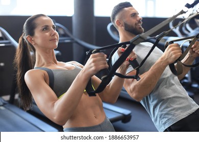 Young Couple On Body Training With Trx In Gym