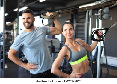 Young Couple On Body Training With Trx In Gym