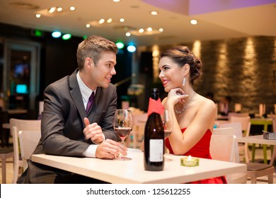 Young couple on first date in romantic restaurant