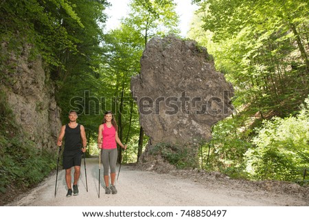 Young couple on a hike at rock formation on a hot summer day