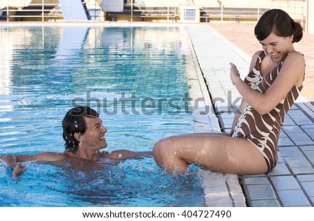 A young couple on holiday by the pool