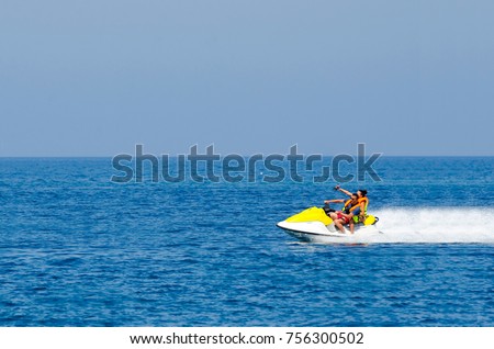 Young Couple on Jet Ski fast ride, Tropical Ocean, Vacation Concept