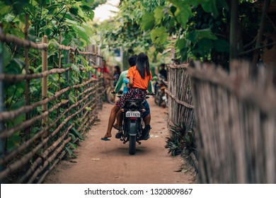 Young Couple On Motorbike In Cebu Island Philippines Village Dirt Road Fence  