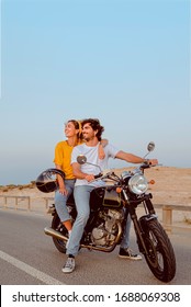 young couple on motorcycle on a road traveling to the beach. photo lifestyle