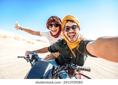 Young couple on a off road adventure excursion outside - Joyful tourists taking selfie with smart mobile phone in the desert - Tourism tour activities, transportation and summertime holidays concept - Powered by Shutterstock