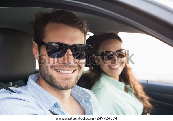 Young couple on a road\
trip in their car