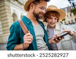 Young couple, on a vacation, exploring the new city and using their phone as gps to help them not get lost.