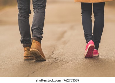 Young Couple / Pair Walking Down The Street.