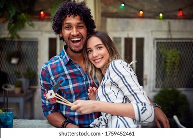 Young Couple At A Party Posing For Photo