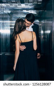 Young Couple Passionately Kissing And Hugging In Elevator