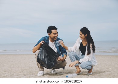 Young couple people cleaning beach area, Young Volunteer cleaning beach. - Powered by Shutterstock