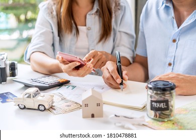 Young Couple Is Planning And Managing Home Expenses (house, Car, Travel, And Credit Card) Together At Home