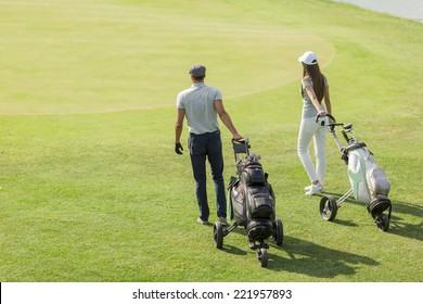 Young Couple Playing Golf