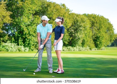 Young Couple Playing Golf