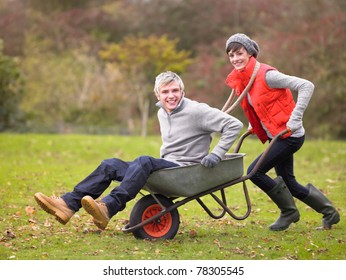 Young Couple Playing In Wheelbarrow