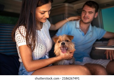 Young Couple Portrait With Dog Inside Van. Romantic Lifestyle Real Image Of Vacation On The Road. Shallow Depth Of Field.